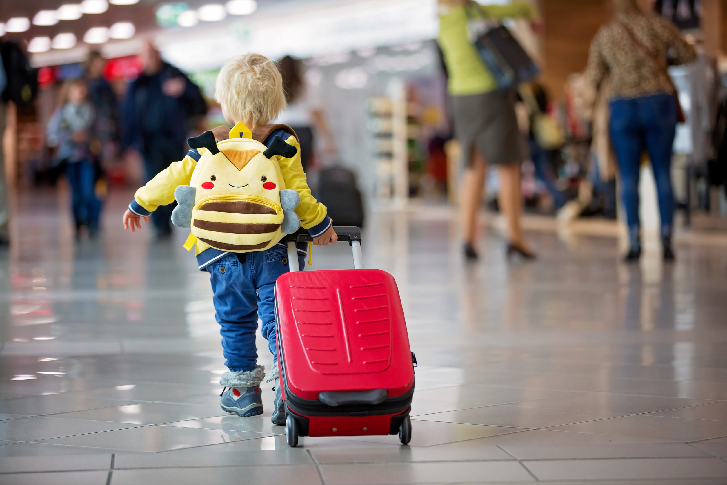 Baby Boy Carrying Luggage In Airport Transit Hall