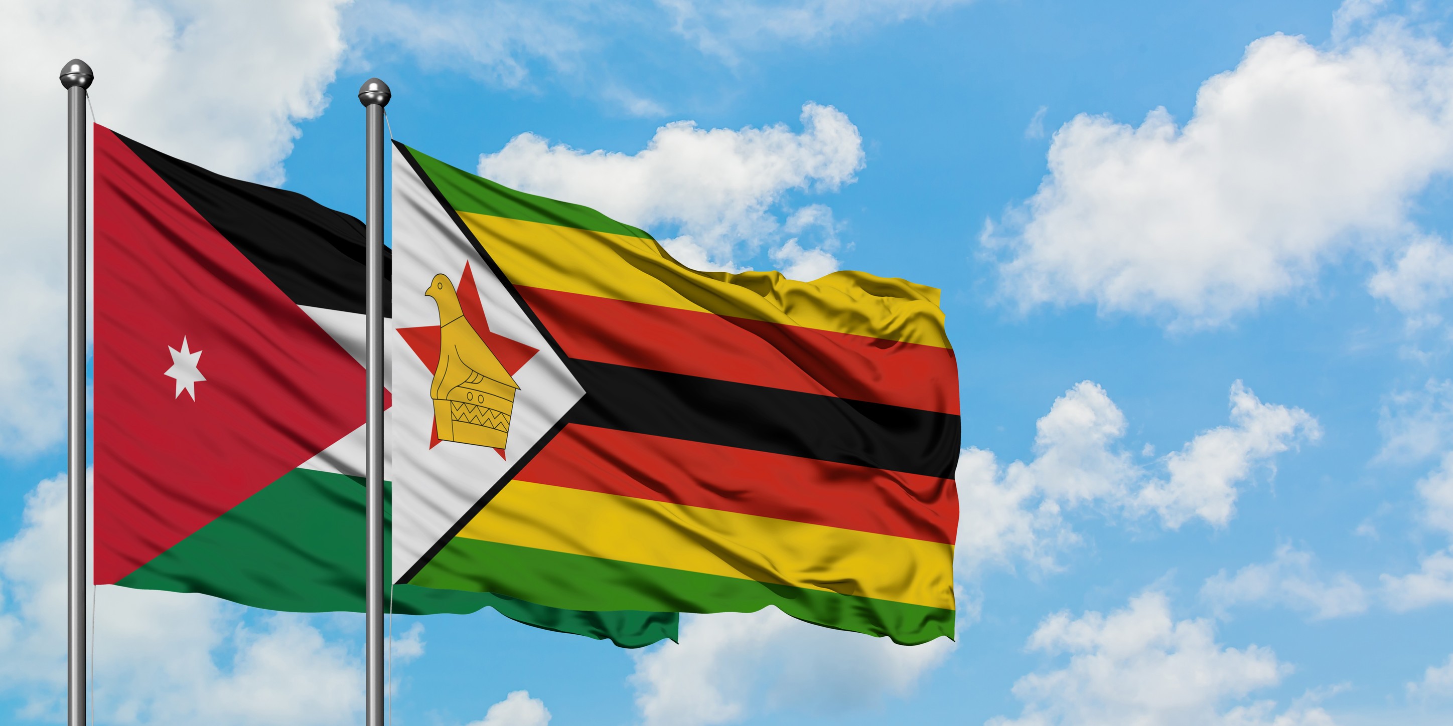drapeaux de la Jordanie et du Zimbabwe flottant