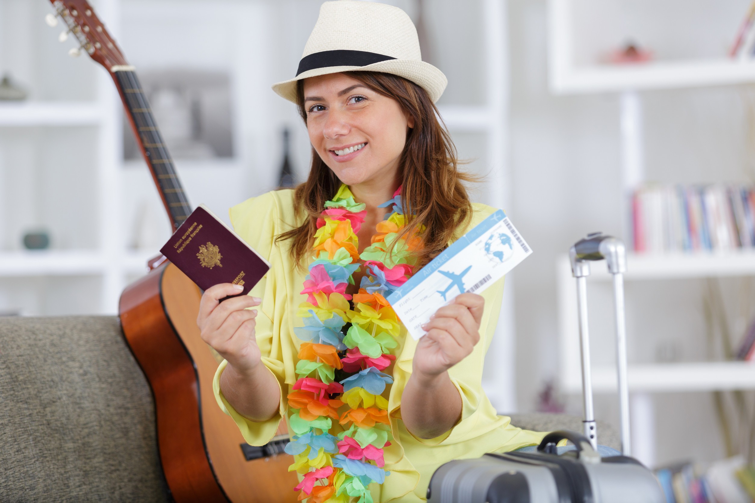 portrait of young lady holding passport and air tickets