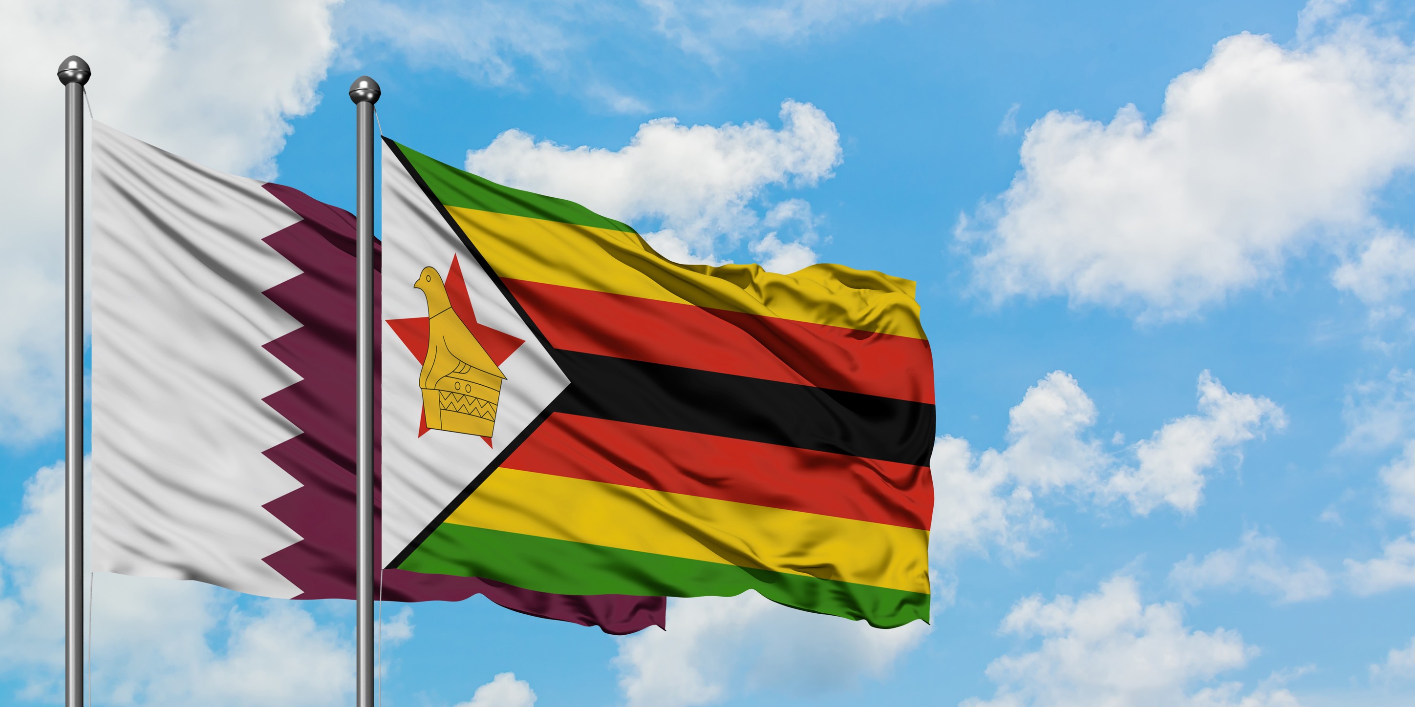 qatar and zimbabwe flag waving