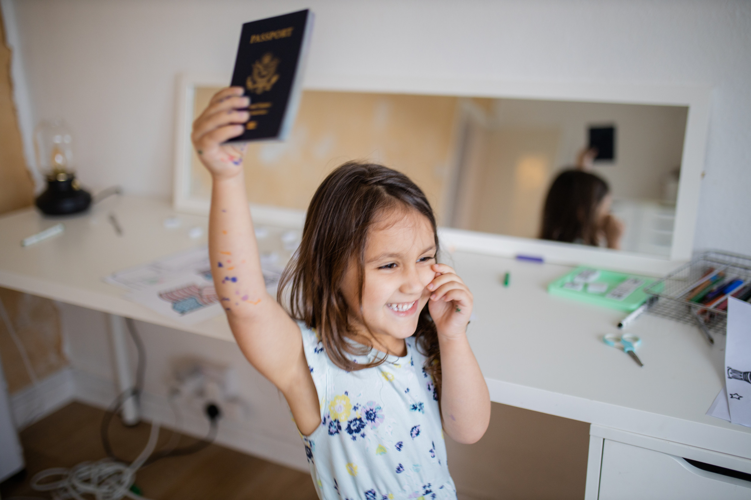 Little Girl Holding A Passport In Hand