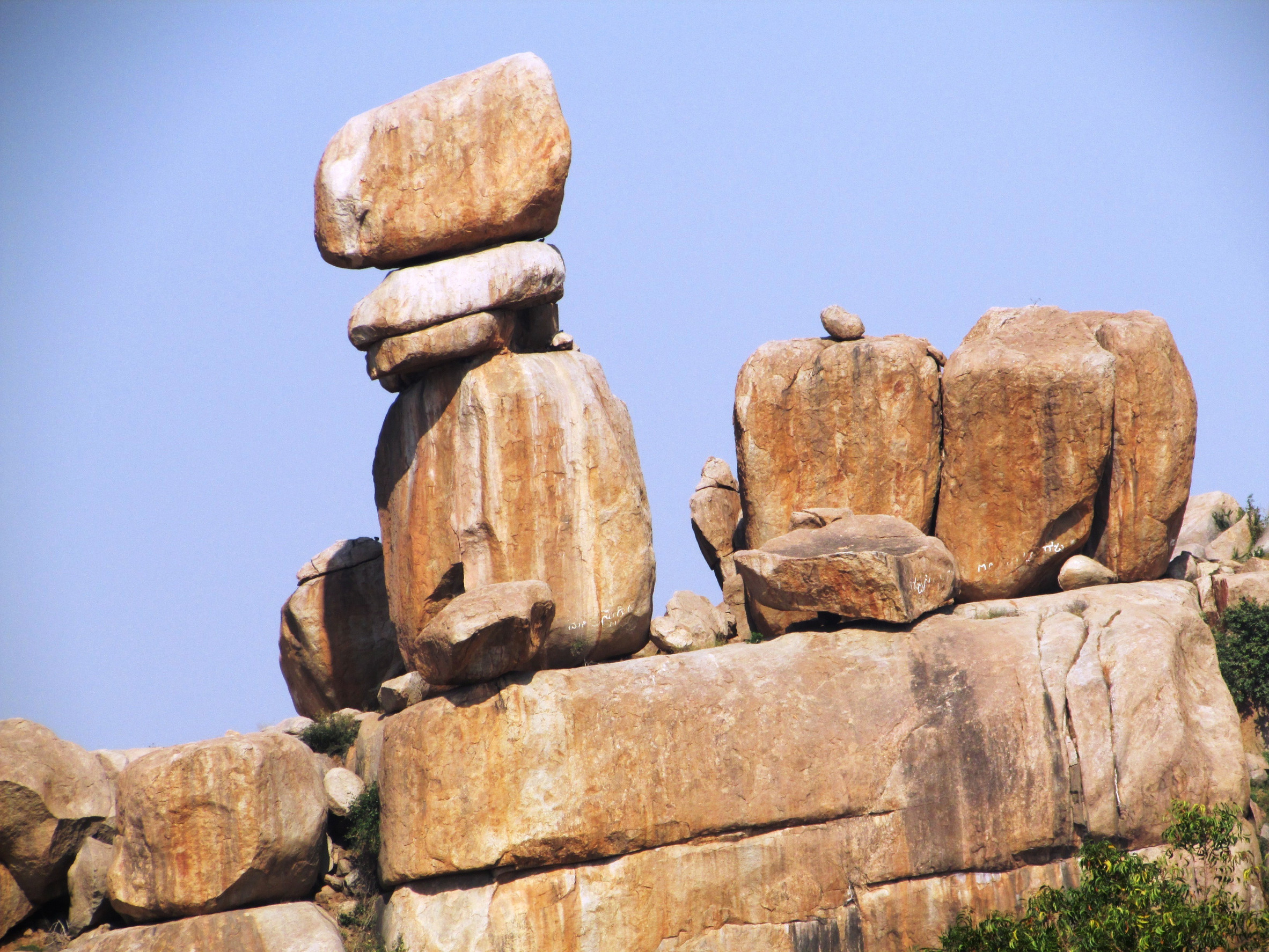 Several large, balanced rocks on top of a hill