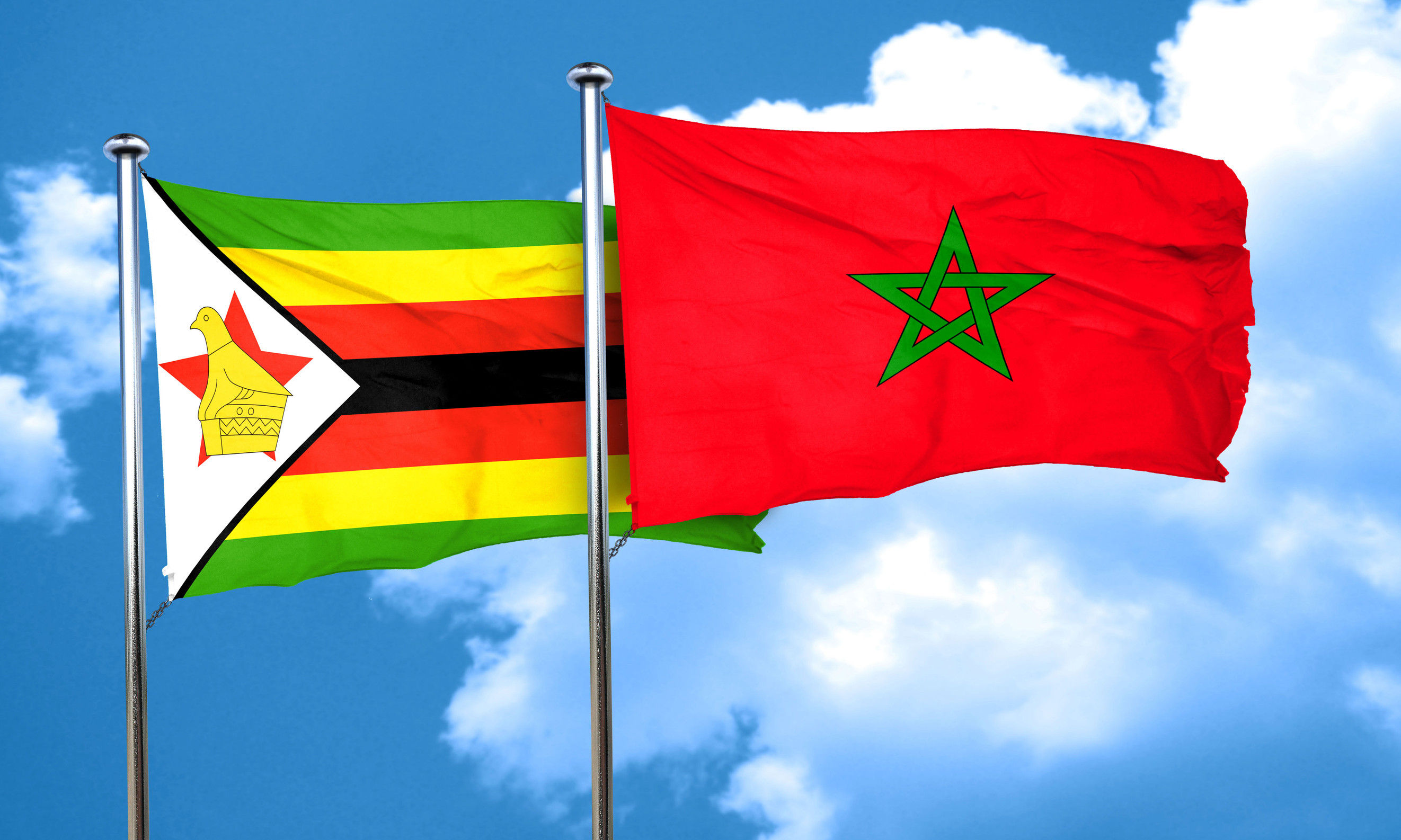 Two flags, Zimbabwe and Morocco, waving side by side